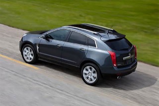 Overhead view of a black SRX rolling down the road