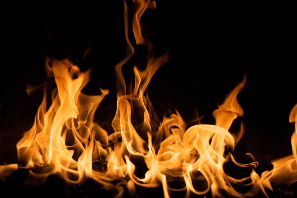 An orange and yellow flame on a black background