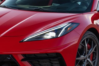 The front trunk of a red Corvette.