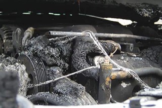 An overly corroded engine bay. The hoses and pipes all showing significant wear.