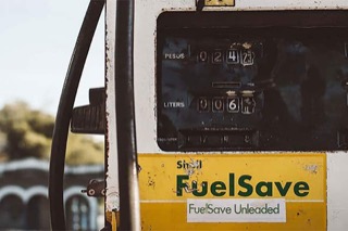 A yellow and white gas pump with the words Fuel Save on the front.