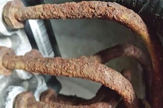 Brown corrosion building up on brake lines.