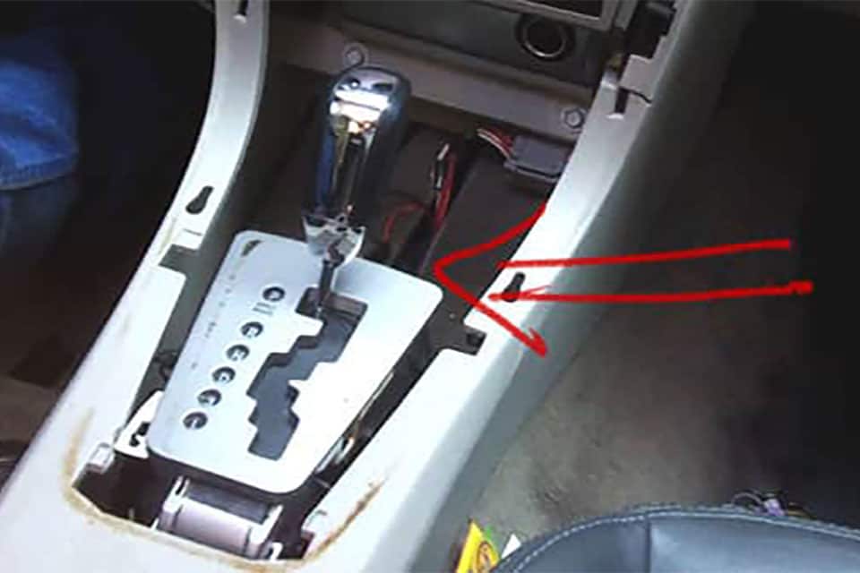 Red arrow points at a disassembled gear shifter