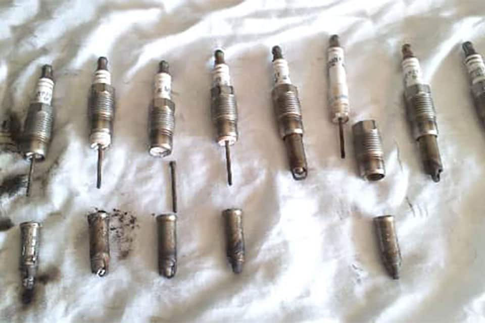 What year did Ford fix the Triton spark plug problem?