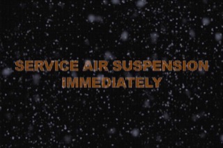 Console Message That Says Service Air Suspension Immediately, With Fake Ice on Top