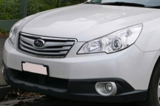 Headlights on a white Subaru Outback
