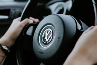 A steering wheel with the VW emblem in the middle