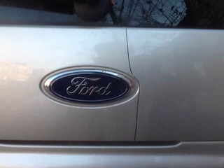 A large crack runs heightwise down a rear body panel, just to the right of the Ford emblem
