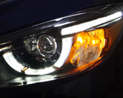 Closeup of a headlight with the daytime running light LED strip illuminated