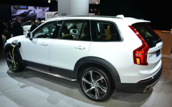 The side of a white XC90 Hybrid at an auto show