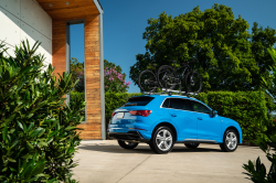 A blue Q3 parked in a modern driveway