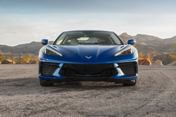 Blue Corvette with golden hour mountains in the background