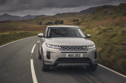 Gray Range Rover Evoque SUV on a country road.