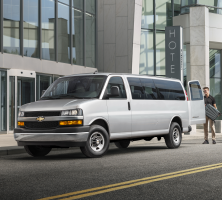 A silver Express van being loaded with cargo through the rear doors