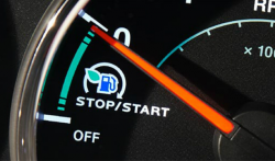 Close up view of a tachometer with the arrow pointing to a stop/start logo