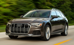 A brown Audi wagon driving down the road