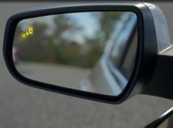 Yellow blind spot warning icon appears on a sideview mirror