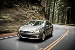 A gray Dart on a windy road