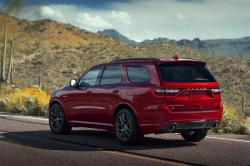 Rear three-quarter view of a red Durango on a desset road.