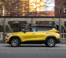 Side view of a yellow Kia SUV