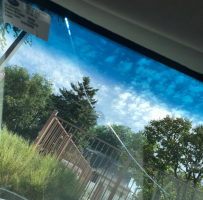 The view of a long, sweeping windshield crack from inside the car