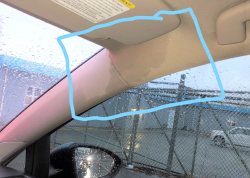 A poorly drawn blue box shows water damage to a car's headliner