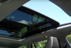 Looking up at a VW panoramic sunroof, half opened